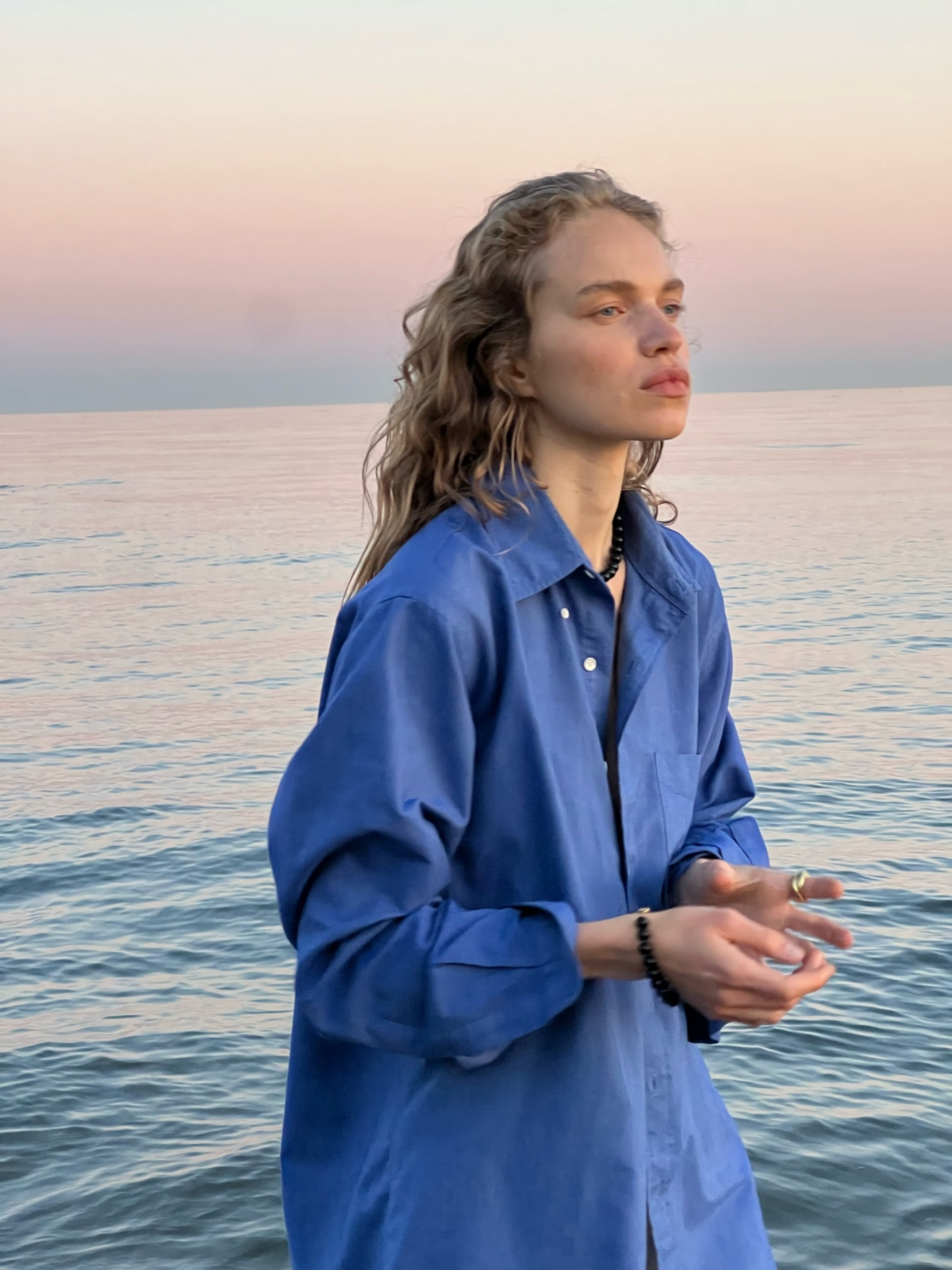 Sabine captured in the pink sunset wearing the Selma Bracelet and Selma Necklace